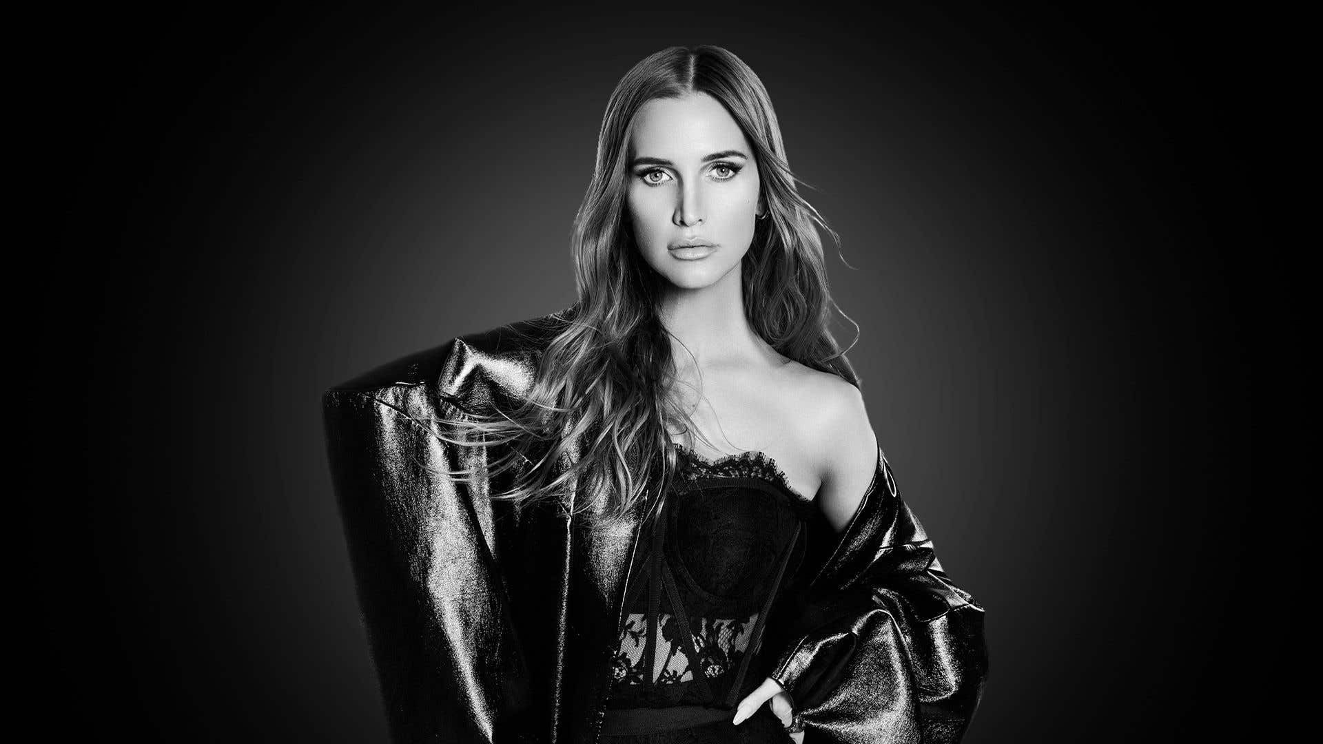 Black & white photo of singer Ashlee Simpson in a shiny jacket.